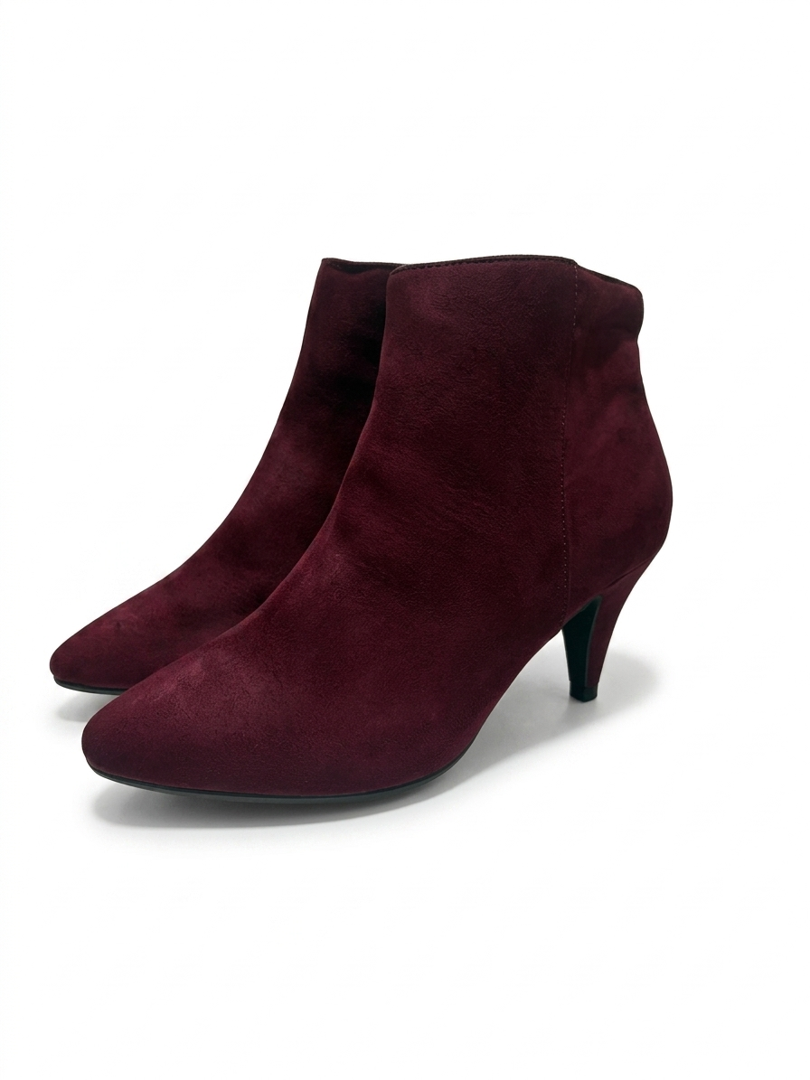 Pair of maroon ankle boots on a white background